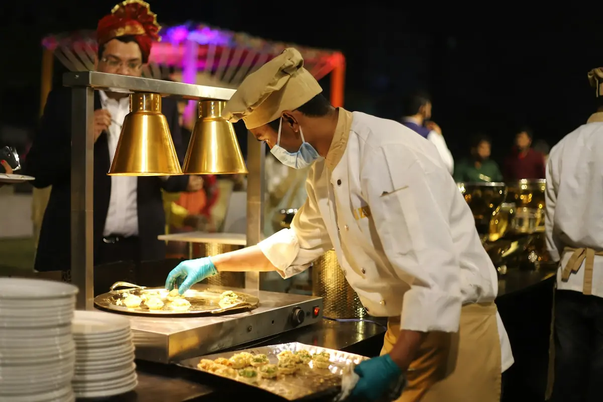 A chef cooking in a commercial kitchen.